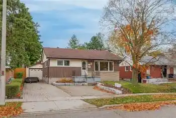 View of front of property featuring a garage and an outdoor structure
