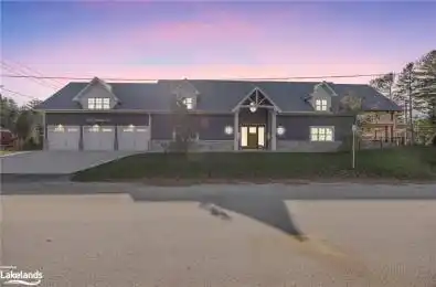 View of front of property featuring a garage and a lawn